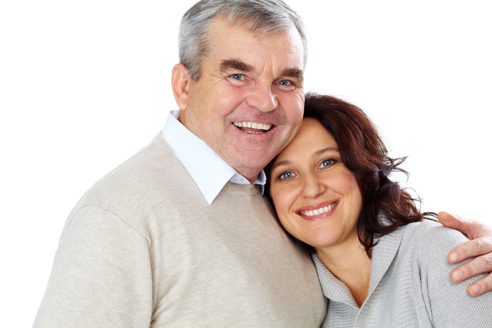 Portrait of happy mature couple looking at camera with smiles